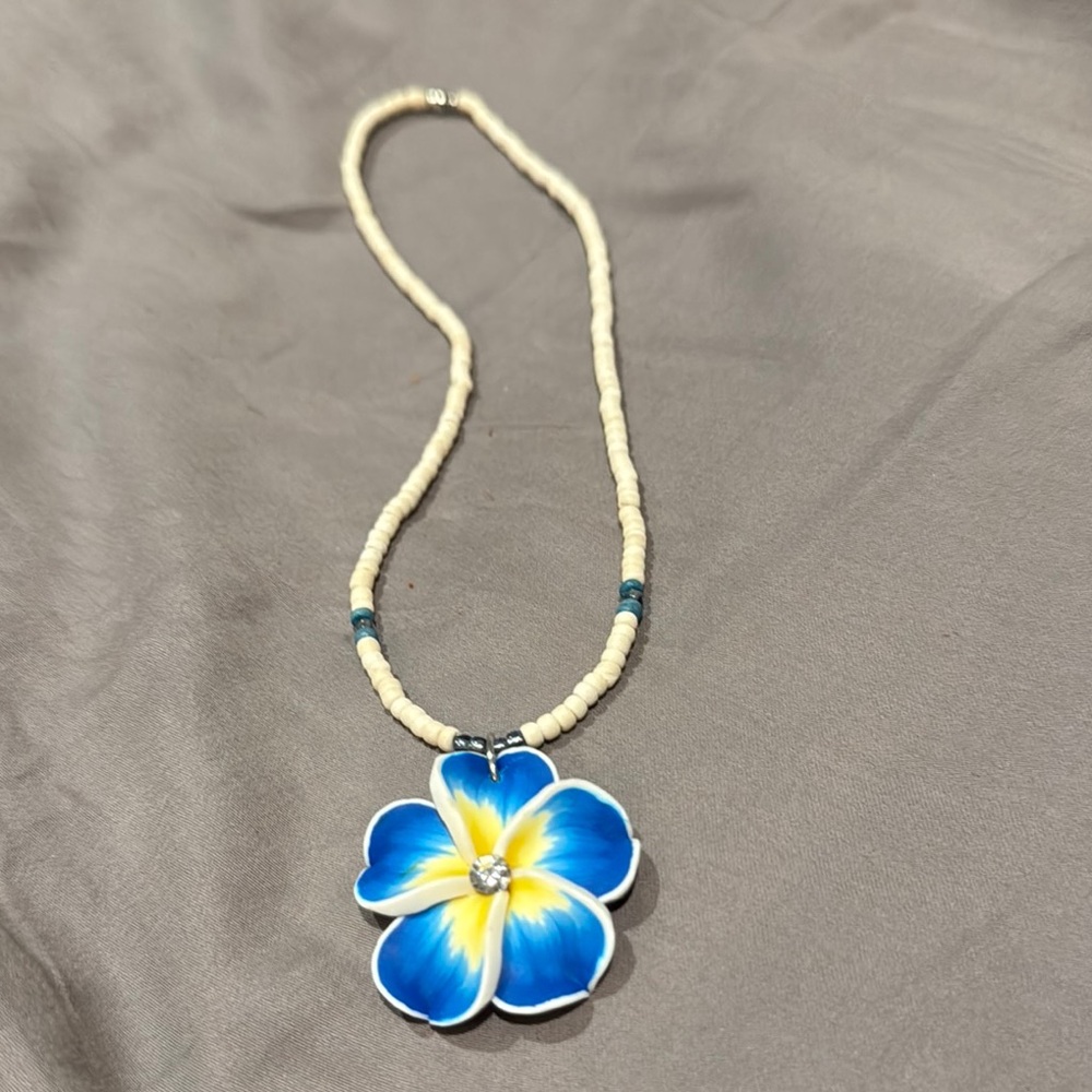 Hawaiis famous shell necklace with Blue and Yellow Floral Pendant